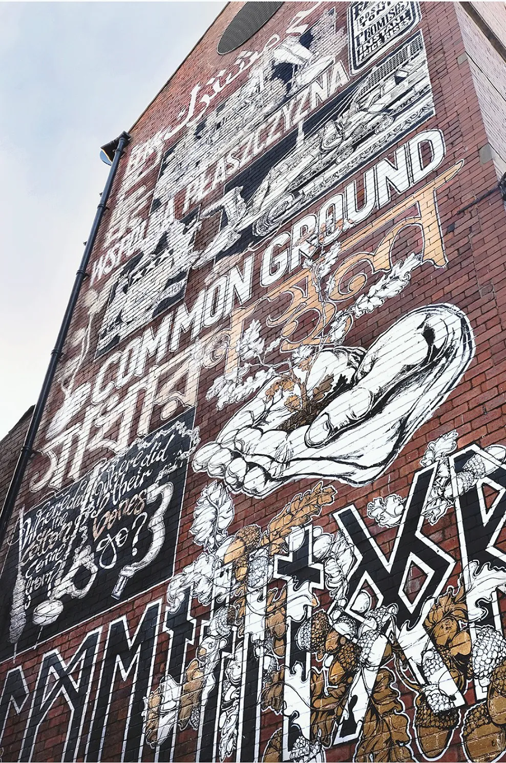 The full height of the mural on the brick building.